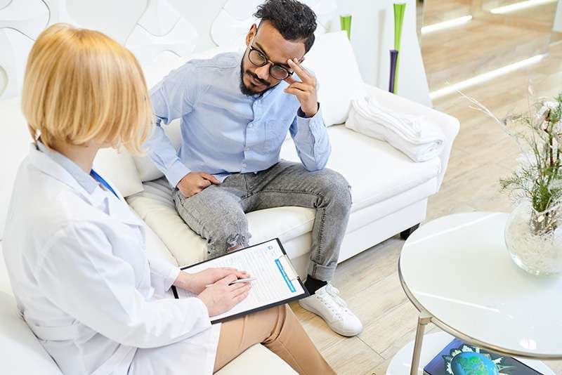 Doctor consulting with patient in clinic.